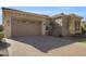 A tan house with a two-car garage and paver driveway at 2091 E Geronimo St, Chandler, AZ 85225