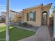 Tan house with stone accents, arched entryway, and a landscaped yard at 2091 E Geronimo St, Chandler, AZ 85225