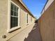 Side yard with paved pathway and a brick wall at 2091 E Geronimo St, Chandler, AZ 85225