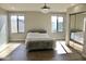 Main bedroom with wood flooring, large windows, and mirrored closets at 23306 N 40Th Pl, Phoenix, AZ 85050