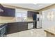 Galley style kitchen with dark brown cabinets and granite countertops at 2348 W Laurel Ln, Phoenix, AZ 85029