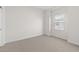 Simple bedroom with neutral carpeting and large window at 2822 W White Feather Ln, Phoenix, AZ 85085