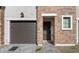 Townhouse exterior featuring a brick facade, attached garage, and walkway at 2822 W White Feather Ln, Phoenix, AZ 85085