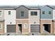 Three-unit townhome building with attached garages and neutral color palette at 2822 W White Feather Ln, Phoenix, AZ 85085