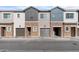 Three-unit townhome building with attached garages and neutral color palette at 2822 W White Feather Ln, Phoenix, AZ 85085