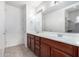 Double vanity bathroom with wood cabinets and a large mirror at 3330 S Gilbert Rd # 2001, Chandler, AZ 85286