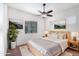 Main bedroom with ceiling fan, wood bed frame and window at 3330 S Gilbert Rd # 2001, Chandler, AZ 85286