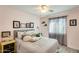 Cozy bedroom with gray bedding, ceiling fan, and a soft pink wall at 3343 E Anderson Dr, Phoenix, AZ 85032