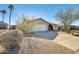 Single-story home with a two-car garage and desert landscaping at 3343 E Anderson Dr, Phoenix, AZ 85032