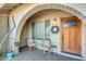 Arched entryway with two wicker chairs and potted plants at 3343 E Anderson Dr, Phoenix, AZ 85032