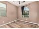 Bedroom with wood-look flooring and an arched window at 3667 S 185Th Dr, Goodyear, AZ 85338