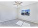 Bright bedroom with grey carpet, ceiling fan, and large window at 3730 N Maya Rd, Eloy, AZ 85131