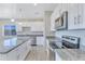 Modern kitchen with white cabinets, granite countertops, and stainless steel appliances at 3730 N Maya Rd, Eloy, AZ 85131