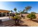 Landscaped backyard with pergola, gravel, and desert plants at 3832 N 162Nd Ln, Goodyear, AZ 85395