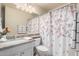 Clean bathroom with single sink and floral shower curtain at 3832 N 162Nd Ln, Goodyear, AZ 85395