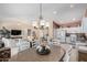 Charming dining area with a rustic table and view into the kitchen at 3832 N 162Nd Ln, Goodyear, AZ 85395