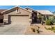 Tan house with cacti and gravel landscaping at 3832 N 162Nd Ln, Goodyear, AZ 85395