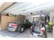 Garage with golf cart, car, and ample storage space at 3832 N 162Nd Ln, Goodyear, AZ 85395