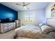 Spacious bedroom with a king-size bed and blue accent wall at 40634 W Hillman Dr, Maricopa, AZ 85138