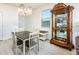 Bright dining area with a table and chairs, and a display cabinet at 40634 W Hillman Dr, Maricopa, AZ 85138