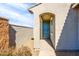 Inviting exterior with a teal door and walkway at 40634 W Hillman Dr, Maricopa, AZ 85138