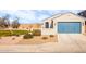 Charming house with a blue garage door and landscaped yard at 40634 W Hillman Dr, Maricopa, AZ 85138