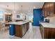 Modern kitchen with stainless steel appliances and a blue accent wall at 40634 W Hillman Dr, Maricopa, AZ 85138