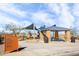 Community playground with shaded seating and play equipment at 40634 W Hillman Dr, Maricopa, AZ 85138