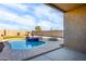 Inviting backyard with a refreshing pool and covered patio at 40634 W Hillman Dr, Maricopa, AZ 85138