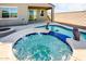 Relaxing backyard oasis featuring a sparkling pool and hot tub at 40634 W Hillman Dr, Maricopa, AZ 85138