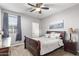 Charming bedroom with a comfortable bed, nightstand, and ceiling fan at 4124 E Toledo St, Gilbert, AZ 85295