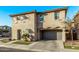 Tan two-story home with gray garage and landscaping at 4124 E Toledo St, Gilbert, AZ 85295