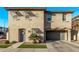 Tan two-story home with gray garage door and landscaping at 4124 E Toledo St, Gilbert, AZ 85295