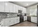 Modern kitchen with white cabinets, granite counters, and stainless steel appliances at 4124 E Toledo St, Gilbert, AZ 85295