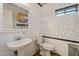 Small bathroom with pedestal sink, toilet and decorative wallpaper at 4360 E Sierrita Rd, San Tan Valley, AZ 85143