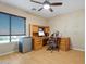 Home office with wood desk, computer, and mini-fridge at 4360 E Sierrita Rd, San Tan Valley, AZ 85143