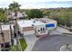 Aerial view of a charming home with a flat roof, blue awning, and landscaped surroundings at 4605 E Valley View Dr, Phoenix, AZ 85044