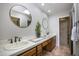 Double vanity bathroom with wood cabinets and tiled accents at 4605 E Valley View Dr, Phoenix, AZ 85044