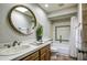 Bathroom with single vanity, tiled shower and updated fixtures at 4605 E Valley View Dr, Phoenix, AZ 85044