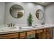 Double vanity bathroom with wood cabinets and tiled accents at 4605 E Valley View Dr, Phoenix, AZ 85044