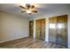 Bedroom with wood flooring, ceiling fan and large closet at 4605 E Valley View Dr, Phoenix, AZ 85044