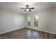 Bright bedroom with wood flooring, ceiling fan and plantation shutters at 4605 E Valley View Dr, Phoenix, AZ 85044