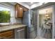 Kitchen with stainless steel appliances and granite countertops, adjacent to the dining area at 4605 E Valley View Dr, Phoenix, AZ 85044