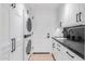 Laundry room with stacked washer/dryer and white cabinets at 5101 N Casa Blanca Dr # 301, Paradise Valley, AZ 85253