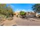 Desert landscape surrounds this one-story home with stucco exterior and attached garage at 5743 E Windstone Trl, Cave Creek, AZ 85331