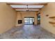 Living room with tile floors, fireplace, and sliding glass doors to backyard at 5743 E Windstone Trl, Cave Creek, AZ 85331