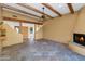 Spacious living room with tile floors, fireplace and exposed wood beams at 5743 E Windstone Trl, Cave Creek, AZ 85331