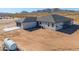 Aerial view of house with large backyard and mountain views at 57968 W Fulcar Rd, Maricopa, AZ 85139