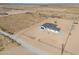 Aerial view of house and lot with desert landscape and distant mountains at 57968 W Fulcar Rd, Maricopa, AZ 85139