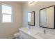 Clean bathroom with double vanity and mirrors at 57968 W Fulcar Rd, Maricopa, AZ 85139